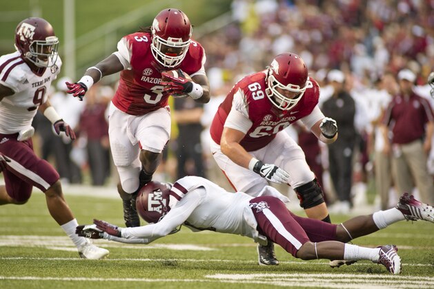 Texas A&M defensive back De'Vante Harris (1) attempts a tackle on Arkansas Razorbacks running back Alex Collins (3) as offensive tackle David Hurd defends during an NCAA college football game in Fayetteville, Ark., Saturday, Sept. 28, 2013. Texas A&M defeated Arkansas 45-33. (AP Photo/Beth Hall)