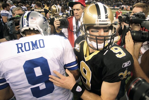 New Orleans Saints quarterback Drew Brees taps Dallas Cowboys quarterback Tony Romo on the back as he passes him after an NFL football game, Saturday, Dec. 19, 2009, in New Orleans.  Dallas won 24 - 17. (AP Photo/Dave Martin)