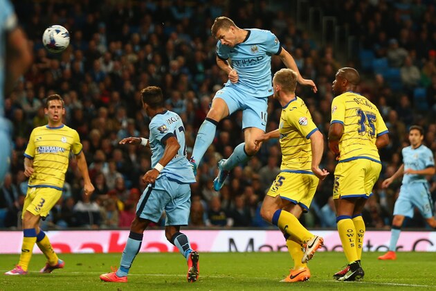 MANCHESTER, ENGLAND - SEPTEMBER 24:  Edin Dzeko of Manchester City scores his sides fifth goal during the Capital One Cup Third Round match between Manchester City and Sheffield Wednesday at the Etihad Stadium on September 24, 2014 in Manchester, England.  (Photo by Michael Steele/Getty Images)