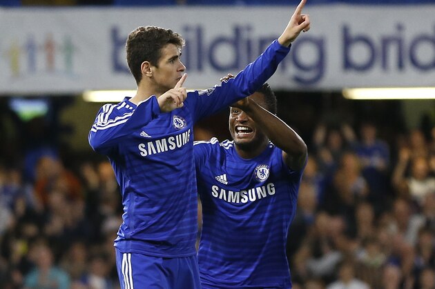 Chelsea's Oscar, left, celebrates scoring a goal with John Obi Mikel during the English League Cup soccer match between Chelsea and Bolton Wanderers at Stamford Bridge Stadium in London, Wednesday, Sept. 24, 2014. (AP Photo/Kirsty Wigglesworth)