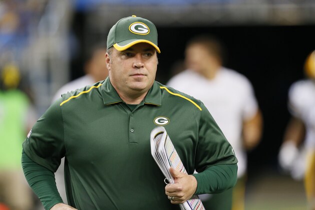 Green Bay Packers head coach Mike McCarthy runs onto the field before the first half of an NFL football game against the Detroit Lions in Detroit, Sunday, Sept. 21, 2014. (AP Photo/Paul Sancya)