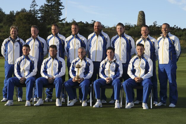 The European team captain Paul McGinley, front center, holds the Ryder Cup trophy during a team photo ahead of the Ryder Cup golf tournament at Gleneagles, Scotland, Tuesday, Sept. 23, 2014. (AP Photo/Scott Heppell)