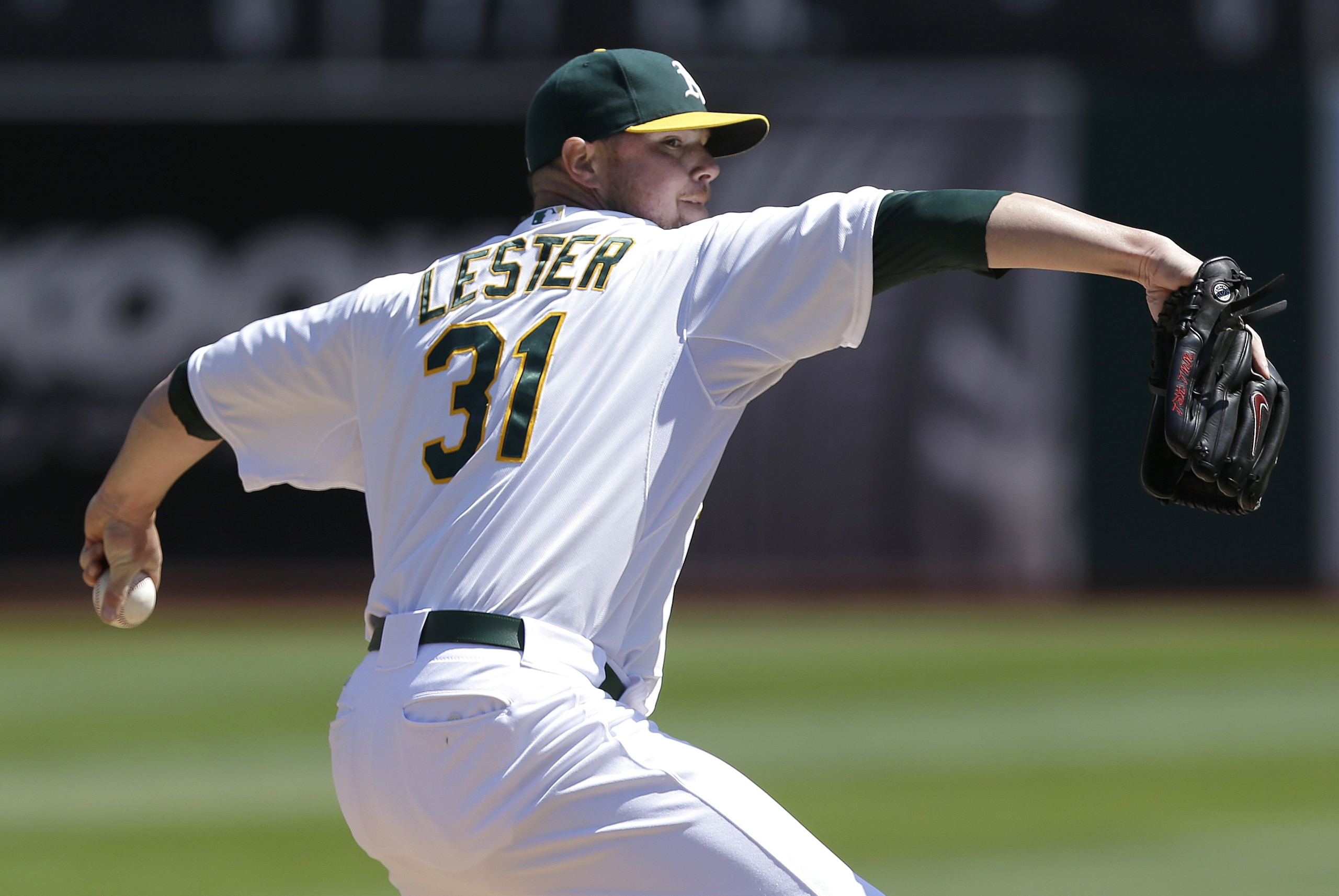 Oakland Athletics pitcher Jon Lester (31) throws against the Seattle Mariners during the first inning of a baseball game in Oakland, Calif., Wednesday, Sept. 3, 2014. (AP Photo/Jeff Chiu)