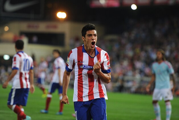 MADRID, SPAIN - SEPTEMBER 20:  Raul Jimenez of Club Atletico de Madrid celebrates after beating Sergio Alvarez of Real Club Celta de Vigo to put the ball in the net during the La Liga match at the Vicente Calderon stadium on September 20, 2014 in Madrid, Spain.  The goal was disallowed.  (Photo by Denis Doyle/Getty Images)