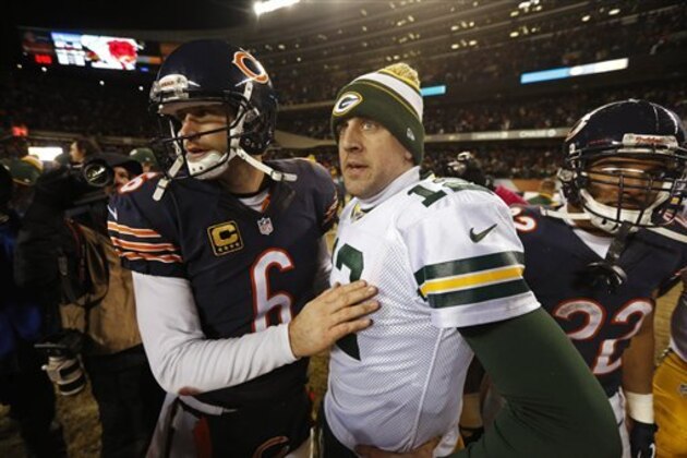 Green Bay Packers quarterback Aaron Rodgers (12) talks to Chicago Bears quarterback Jay Cutler (6) after their NFL football game, Sunday, Dec. 29, 2013, in Chicago. The Packers won 33-28 to capture the NFC North title. (AP Photo/Charles Rex Arbogast)