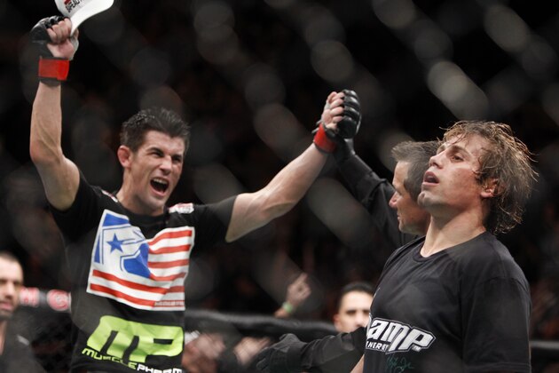 Dominick Cruz, left, celebrates his victory over Urijah Faber shortly their UFC bantamweight mixed martial arts title match, Saturday, July 2, 2011 at The MGM Grand Garden Arena in Las Vegas. Cruz won by unanimous decision. (AP Photo/Eric Jamison)