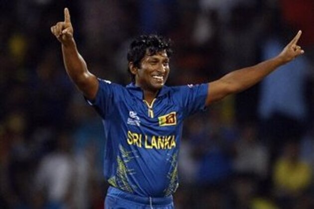 Sri Lanka's bowler Jeevan Mendis celebrates after taking the wicket of England's batsman Ravi Bopara, not seen, during the ICC Twenty20 Cricket World Cup Super Eight match in Pallekele, Sri Lanka, Monday, Oct. 1, 2012. (AP Photo/Aijaz Rahi)