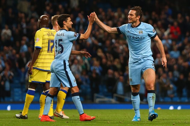 MANCHESTER, ENGLAND - SEPTEMBER 24:  Frank Lampard (R) of Manchester City celebrates with Jesus Navas after scoring the seventh goal during the Capital One Cup Third Round match between Manchester City and Sheffield Wednesday at the Etihad Stadium on September 24, 2014 in Manchester, England.  (Photo by Michael Steele/Getty Images)