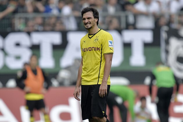 Dortmund's Mats Hummels leaves the pitch disappointed after he saw the red card during the German first division Bundesliga soccer match between Borussia Moenchengladbach and Borussia Dortmund in Moenchengladbach, Germany, Saturday, Oct. 5, 2013. Moenchengladbach defeated Dortmund with 2-0. (AP Photo/Martin Meissner)