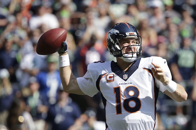 Denver Broncos quarterback Peyton Manning passes in the first half of an NFL football game against the Seattle Seahawks, Sunday, Sept. 21, 2014, in Seattle. (AP Photo/Elaine Thompson)