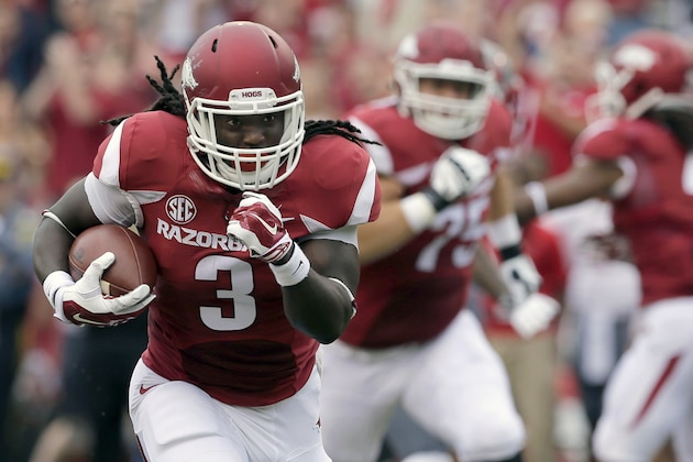 In this photo taken Sept. 6, 2014, Arkansas running back Alex Collins (3) carries in the first quarter of an NCAA college football game against Nicholls in Fayetteville, Ark. The Razorbacks, led by running backs Collins and Jonathan Williams hope to carry the momentum of Arkansas' 73-7 victory ahead to next week at Texas Tech. (AP Photo/Danny Johnston)