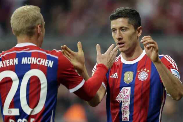 Bayern's Robert Lewandowski from Poland, right, celebrates with teammate Sebastian Rode after scoring his side's second goal during the German first division Bundesliga soccer match between FC Bayern and SC Paderborn 07 in the Allianz Arena in Munich, Germany, on Tuesday, Sept. 23, 2014. (AP Photo/Matthias Schrader)