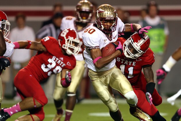 RALEIGH, NC - OCTOBER 06:  Juston Burris #11 of the North Carolina State Wolfpack tackles Rashad Greene #80 of the Florida State Seminoles during their game at Carter-Finley Stadium on October 6, 2012 in Raleigh, North Carolina.  (Photo by Streeter Lecka/Getty Images)