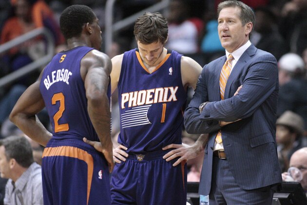 Phoenix Suns head coach Jeff Hornacek, right, talks with Phoenix Suns guard Eric Bledsoe (2) and Phoenix Suns guard Goran Dragic (1) during a break from an NBA basketball game against the Atlanta Hawks Monday, March 24, 2014, in Atlanta. Phoenix defeated Atlanta 102-95. (AP Photo/Jason Getz)