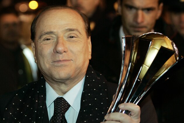 AC Milan's President Silvio Berlusconi  holds the FIFA Club World Cup soccer championship trophy upon arrival at Milan's Malpensa airport, Italy, Monday, Dec. 17, 2007. AC Milan won the FIFA Club World Cup soccer championship final against Boca Junior 4-2. (AP Photo/Antonio Calanni)
