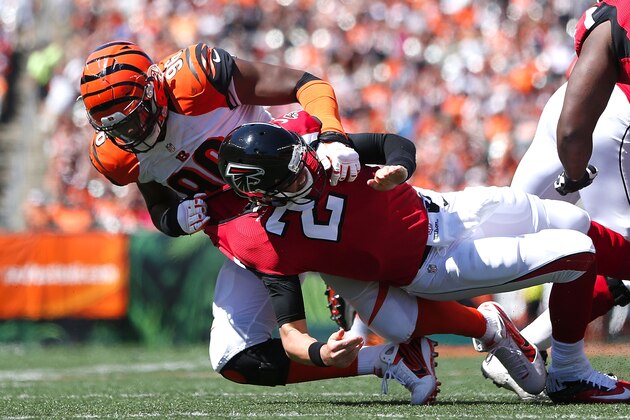 CINCINNATI, OH - SEPTEMBER 14:  Carlos Dunlap #96 of the Cincinnati Bengals knocks down Matt Ryan #2 of the Atlanta Falcons during the second quarter at Paul Brown Stadium on September 14, 2014 in Cincinnati, Ohio. (Photo by Joe Robbins/Getty Images)