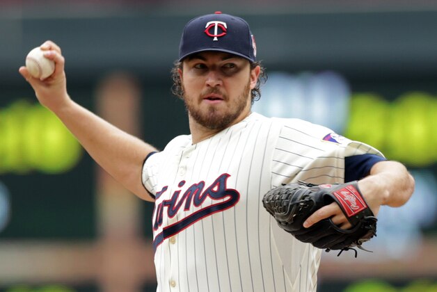 Minnesota Twins pitcher Phil Hughes throws against the Arizona Diamondbacks  in the first inning of a baseball game, Wednesday, Sept. 24, 2014, in Minneapolis. (AP Photo/Jim Mone)