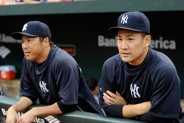 BALTIMORE, MD - AUGUST 11:  Hiroki Kuroda #18 and Masahiro Tanaka #19 of the New York Yankees stand at the top of the dugout before the game against the Baltimore Orioles at Oriole Park at Camden Yards on August 11, 2014 in Baltimore, Maryland.  (Photo by Greg Fiume/Getty Images)