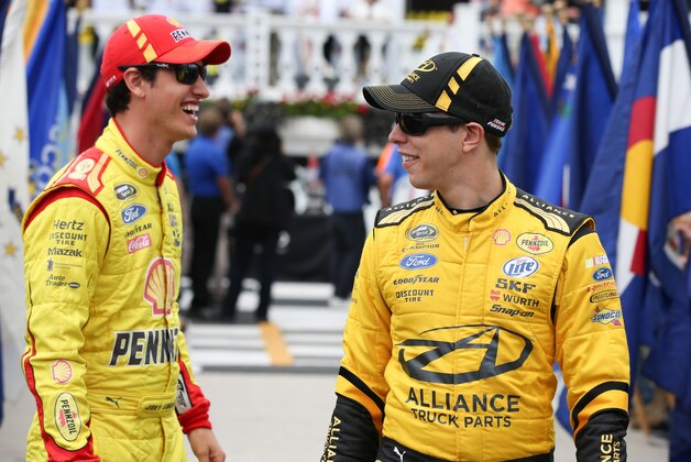 Aug 3, 2014; Long Pond, PA, USA; NASCAR Sprint Cup Series driver Joey Logano (L) and driver Brad Keselowski (2) share a laugh prior to the GoBowling.com 400 at Pocono Raceway. Mandatory Credit: Bill Streicher-USA TODAY Sports