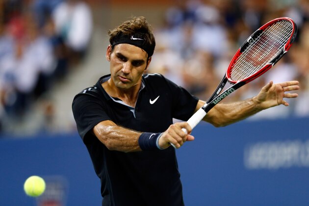 NEW YORK, NY - SEPTEMBER 04:  Roger Federer of Switzerland returns a shot against Gael Monfils of France during their men's singles quarterfinal match on Day Eleven of the 2014 US Open at the USTA Billie Jean King National Tennis Center on September 3, 2014 in the Flushing neighborhood of the Queens borough of New York City.  (Photo by Julian Finney/Getty Images)