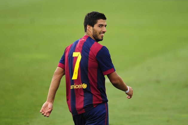 FC Barcelona's Luis Suarez smiles during a friendly soccer match between FC Barcelona B and Indonesia's under-19 national team at the Sports Center FC Barcelona Joan Gamper in San Joan Despi, Spain, Wednesday, Sept. 24, 2014. (AP Photo/Manu Fernandez)