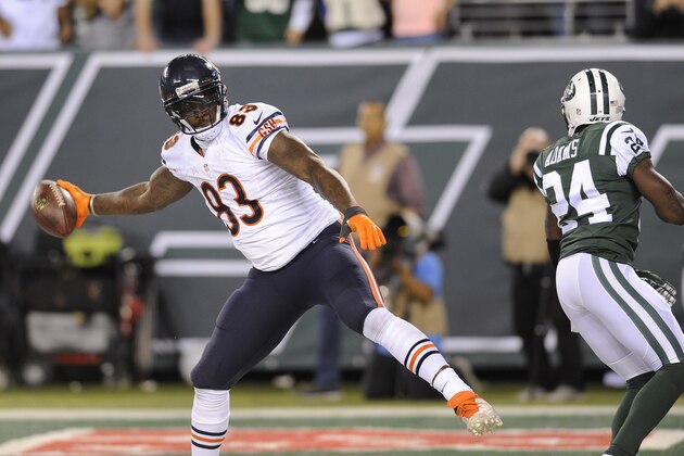 Chicago Bears tight end Martellus Bennett (83) spikes the ball after catching a touchdown pass against New York Jets defensive back Phillip Adams (24) in the third quarter of an NFL football game, Monday, Sept. 22, 2014, in East Rutherford, N.J. (AP Photo/Bill Kostroun)