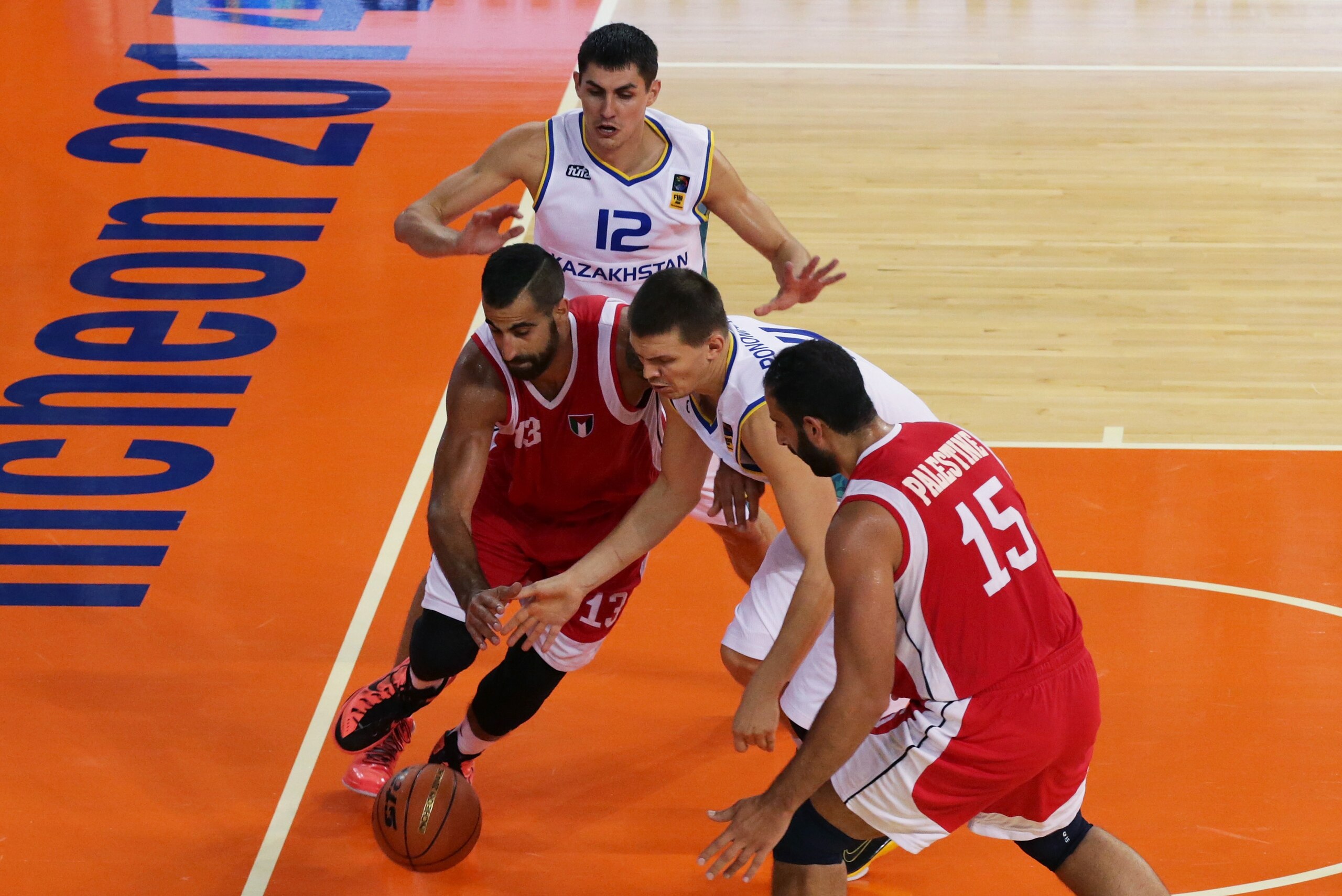 INCHEON, SOUTH KOREA - SEPTEMBER 21:  Hand Sani Sakakini of Palestine competes for the ball with Anton Ponomarev of Kazakhstan in the Qualifying Round-group B at Samsan World Gymnasium during the 2014 Asian Games at on September 21, 2014 in Incheon, South Korea.  (Photo by Chung Sung-Jun/Getty Images)