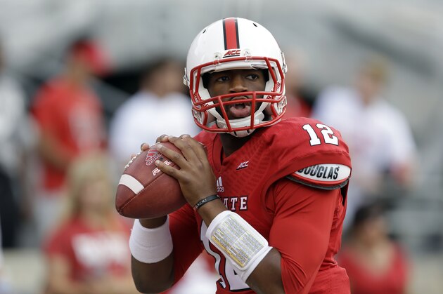 North Carolina State quarterback Jacoby Brissett (12) warms up prior to an NCAA college football game against Presbyterian in Raleigh, N.C., Saturday, Sept. 20, 2014. (AP Photo/Gerry Broome)
