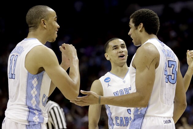North Carolina's James Michael McAdoo (43) celebrates with teammates Brice Johnson (11), and Marcus Paige (5) after being fouled by Providence in the final seconds of the second half of a second-round game in the NCAA college basketball tournament Friday, March 21, 2014, in San Antonio. McAdoo's free throws lifted North Carolina to a 79-77 win over Providence. (AP Photo/David J. Phillip)
