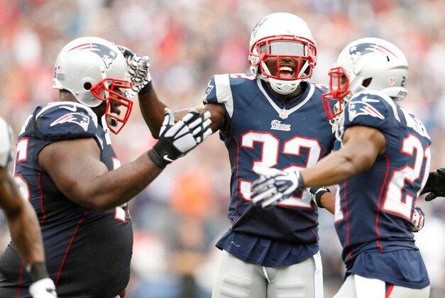 Sep 21, 2014; Foxborough, MA, USA; New England Patriots defensive tackle Vince Wilfork (75) celebrates with safety Devin McCourty (32) and cornerback Malcolm Butler (21) after an interception during the fourth quarter against Oakland Raiders at Gillette Stadium.  The New England Patriots won 16-9.  Mandatory Credit: Greg M. Cooper-USA TODAY Sports