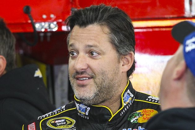 Driver Tony Stewart enjoys a light moment in his garage with crew members before practice for Sunday's NASCAR Sprint Cup auto race at New Hampshire Motor Speedway, Friday, Sept. 19, 2014, in Loudon, N.H.  (AP Photo/Cheryl Senter)