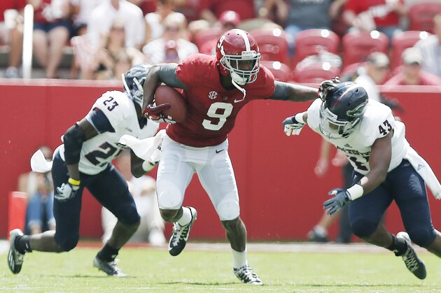 Alabama wide receiver Amari Cooper (9) stiff-arms Florida Atlantic linebacker Robert Relf (43) in the second half of an NCAA college football game Saturday, Sept. 6, 2014, in Tuscaloosa, Ala. (AP Photo/Brynn Anderson)