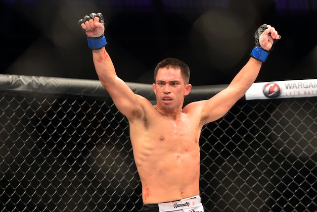 Oct 9, 2013; Sao Paulo, Brazil; Chris Cariaso (blue gloves) celebrates after defeating Iliarde Santos during UFC Fight Night 29 at Jose Correa Arena. Mandatory Credit: Jason Da Silva-USA TODAY Sports