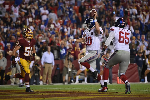 LANDOVER, MD - SEPTEMBER 25: Quarterback Eli Manning #10 of the New York Giants scores a 4th quarter touchdown against the Washington Redskins at FedExField on September 25, 2014 in Landover, Maryland. (Photo by Patrick Smith/Getty Images)