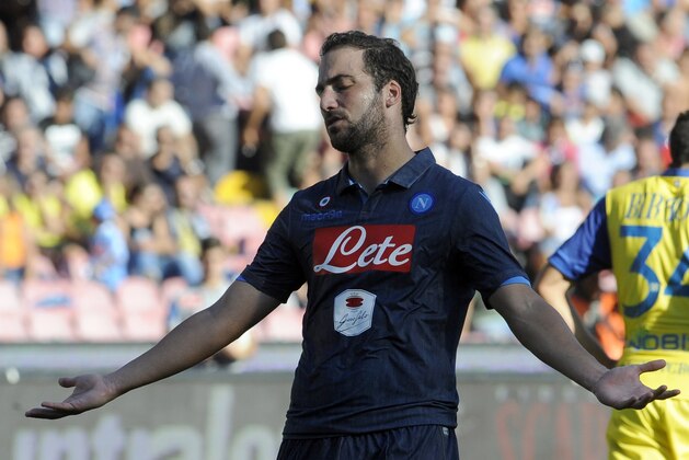 Napoli's Gonzalo Higuain reacts during a Serie A soccer match between Napoli and Chievo, at the San Paolo stadium in Naples, Italy, Sunday, Sept, 14 2014. Chievo won 1-0. (AP Photo/Salvatore Laporta)