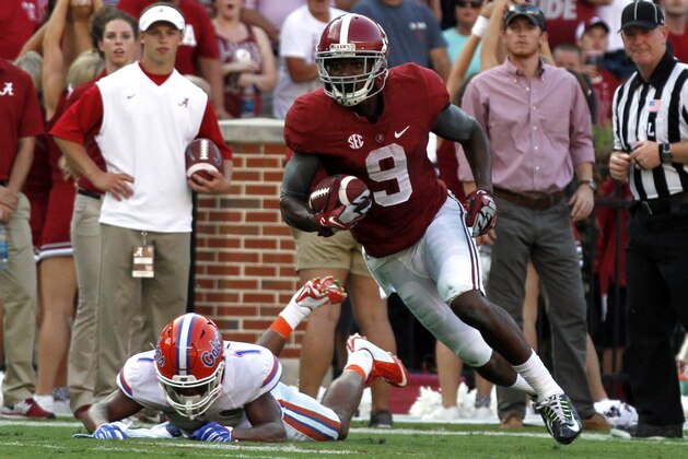 Alabama wide receiver Amari Cooper (9) catches a pass as Florida defensive back Vernon Hargreaves, III (1) falls down during the second half of an NCAA college football game on Saturday, Sept. 20, 2014, in Tuscaloosa, Ala. (AP Photo/Butch Dill)