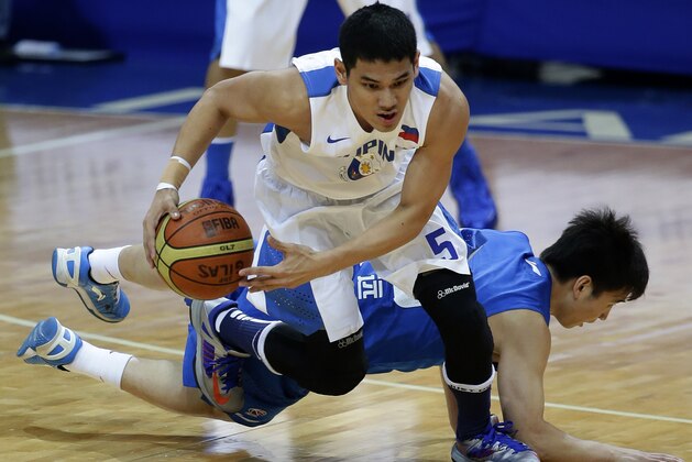 Smart Gilas' Kevin Alas, front, steals the ball from Shanghai Sharks' Zhang Yuan during the first half action of their exhibition basketball match at the Mall of Asia Arena at suburban Pasay city south of Manila, Philippines, Monday, May 6, 2013. The visiting Sharks of which former NBA Houston Rockets basketball player Yao Ming is the manager, lost to the Smart Gilas 72-80. (AP Photo/Bullit Marquez)