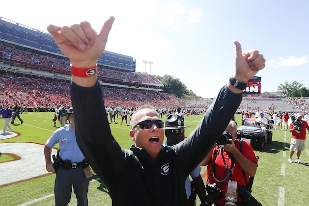 Georgia head coach Mark Richt gestures toward the crowd after defeating Troy 66-0 in an NCAA college football game, Saturday, Sept. 20, 2014, in Athens, Ga. (AP Photo/John Bazemore)