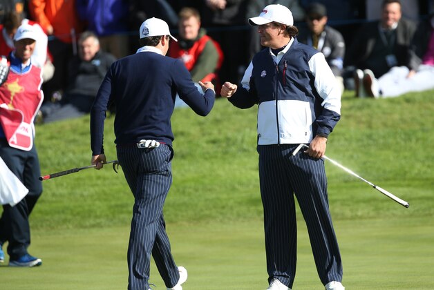 Keegan Bradley, left, and Phil Mickelson, right, of the US celebrate winning the 10th hole during the fourball match on the first day of the Ryder Cup golf tournament, at Gleneagles, Scotland, Friday, Sept. 26, 2014. (AP Photo/Peter Morrison)