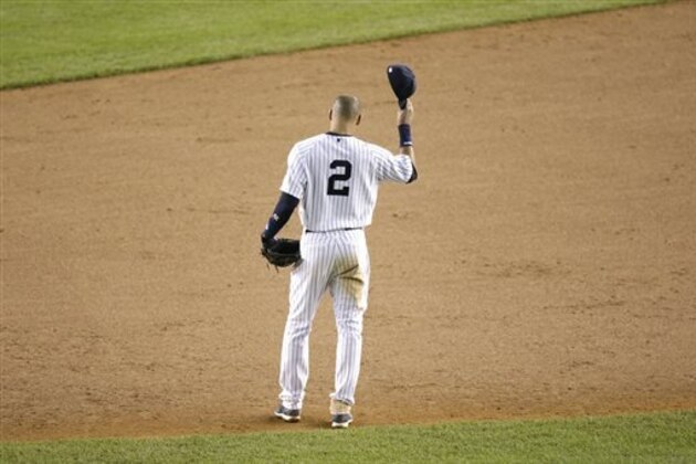 New York Yankees shortstop Derek Jeter waves to fans as he walks around the infield after driving in the winning run against the Baltimore Orioles in the ninth inning of a baseball game, Thursday, Sept. 25, 2014, in New York. The game, which the Yankees won 6-5, was Jeter's last home game of his career. (AP Photo/Bill Kostroun)
