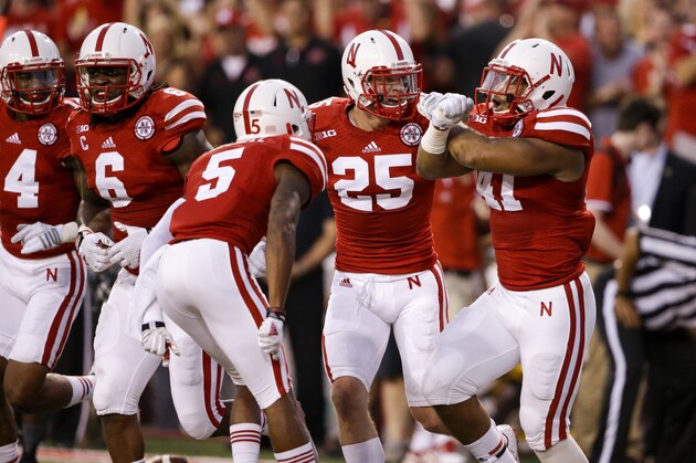 Nebraska linebacker David Santos (41), defensive back Nate Gerry (25), cornerback Josh Mitchell (5), safety Corey Cooper (6) and defensive end Randy Gregory (4) celebrate an interception by Santos in the first half of an NCAA college football game against Miami in Lincoln, Neb., Saturday, Sept. 20, 2014. (AP Photo/Nati Harnik)