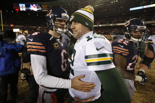 Green Bay Packers quarterback Aaron Rodgers (12) talks to Chicago Bears quarterback Jay Cutler (6) after an NFL football game, Sunday, Dec. 29, 2013, in Chicago. The Packers won 33-28. (AP Photo/Charles Rex Arbogast)