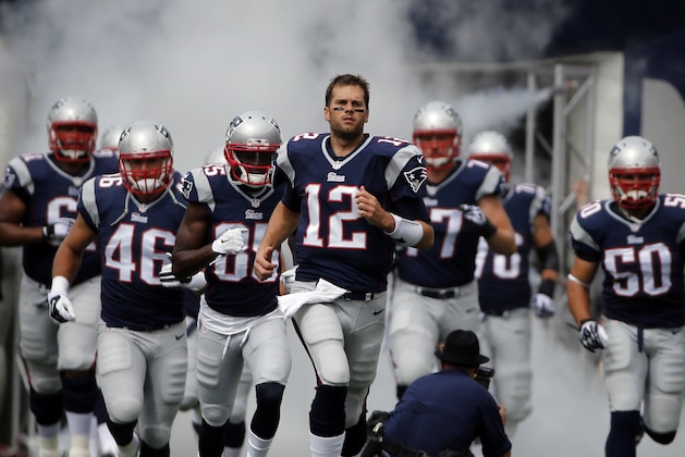 New England Patriots quarterback Tom Brady (12) leads his teammates onto the field before an NFL football game against the Oakland Raiders Sunday, Sept. 21, 2014, in Foxborough, Mass. (AP Photo/Elise Amendola)