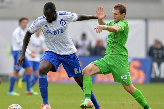 KHIMKI, RUSSIA - MARCH 23: Christopher Samba (L) of FC Dinamo Moscow challenged by Aleksandr Prudnikov of FC Rubin Kazan during the Russian Premier League match between FC Dinamo Moscow and FC Rubin Kazan at the Arena Khimki Stadium on March 23, 2014 in Khimki, Russia.  (Photo by Epsilon/Getty Images)