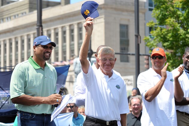 Lou Holtz, Notre Dame football coach 1986-1996 tips his cap, during the Hall of Famer Pep Rally Saturday July 18, 2009 in South Bend, Ind. Coaches and players were introduced and presented with their official Hall of Fame blazers.  At far left is Mark May and far right antoher enshrinee Don McPherson. (AP Photo/Joe Raymond)