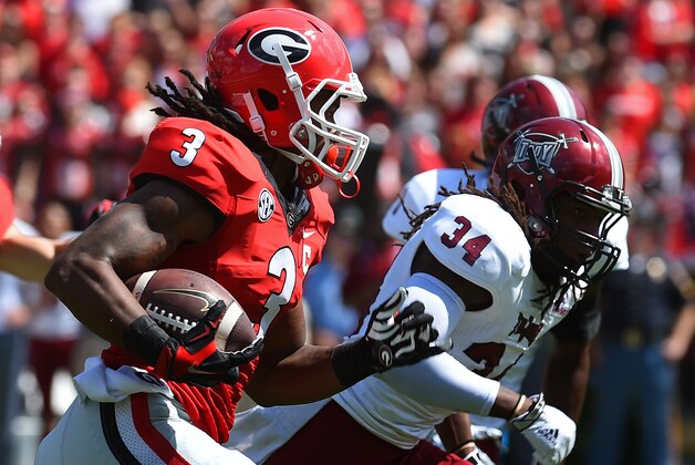 ATHENS, GA - SEPTEMBER 20: Todd Gurley #3 of the Georgia Bulldogs carries the ball against Ethan Davis #34 of the Troy Trojans at Sanford Stadium on September 20, 2014 in Athens, Georgia. (Photo by Scott Cunningham/Getty Images)