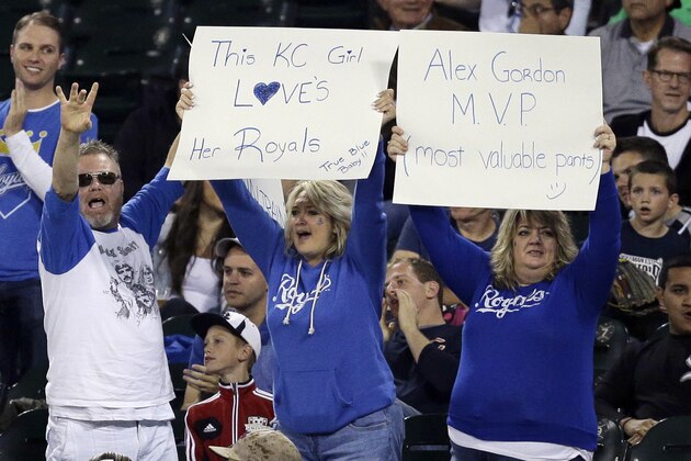 Kansas City Royals fans hold signs as they watch a baseball game between the Kansas City Royals and the Chicago White Sox during the first inning of a baseball game in Chicago on Friday, Sept. 26, 2014. (AP Photo/Nam Y. Huh)