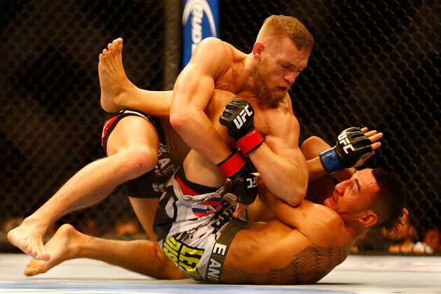 BOSTON, MA - AUGUST 17: Conor McGregor elbows Max Holloway on the ground in their featherweight bout at TD Garden on August 17, 2013 in Boston, Massachusetts. (Photo by Jared Wickerham/Getty Images)