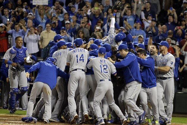 Kansas City Royals players and coaching staff celebrate after the Royals defeated the Chicago White Sox 3-1 in a baseball game in Chicago on Friday, Sept. 26, 2014. (AP Photo/Nam Y. Huh)