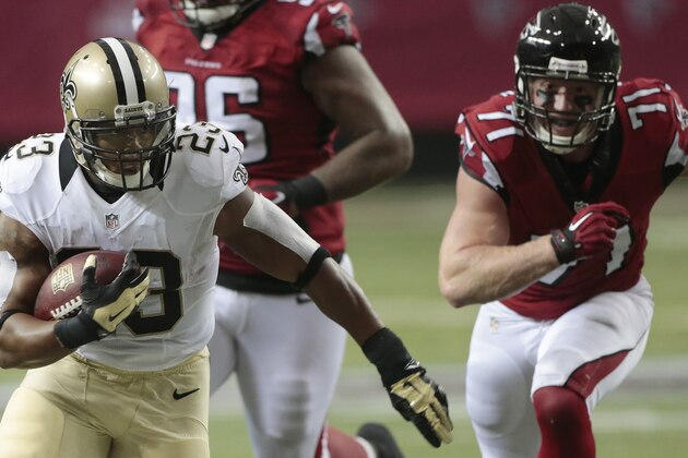 New Orleans Saints running back Pierre Thomas (23) runs the ball against Atlanta Falcons defensive end Kroy Biermann (71) during the first half of an NFL football game, Sunday, Sept. 7, 2014, in Atlanta. (AP Photo/John Bazemore)